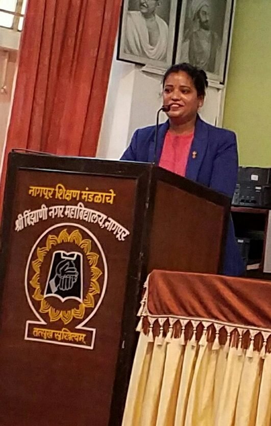A speaking engagement at a college podium.